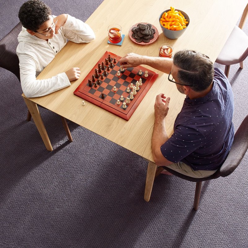 Father is playing chess with son from ICD Flooring in Hermitage